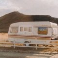 Travel trailer campsite with scenic Idaho nature background and clear blue sky