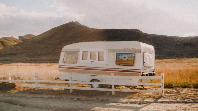 Travel trailer campsite with scenic Idaho nature background and clear blue sky