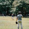 Young athletes competing and practicing baseball skills during travel baseball tryouts outdoors