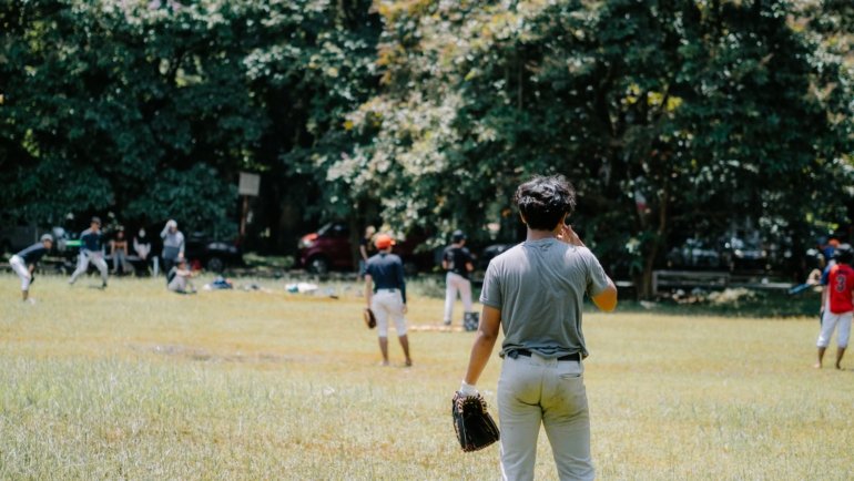 Young athletes competing and practicing baseball skills during travel baseball tryouts outdoors
