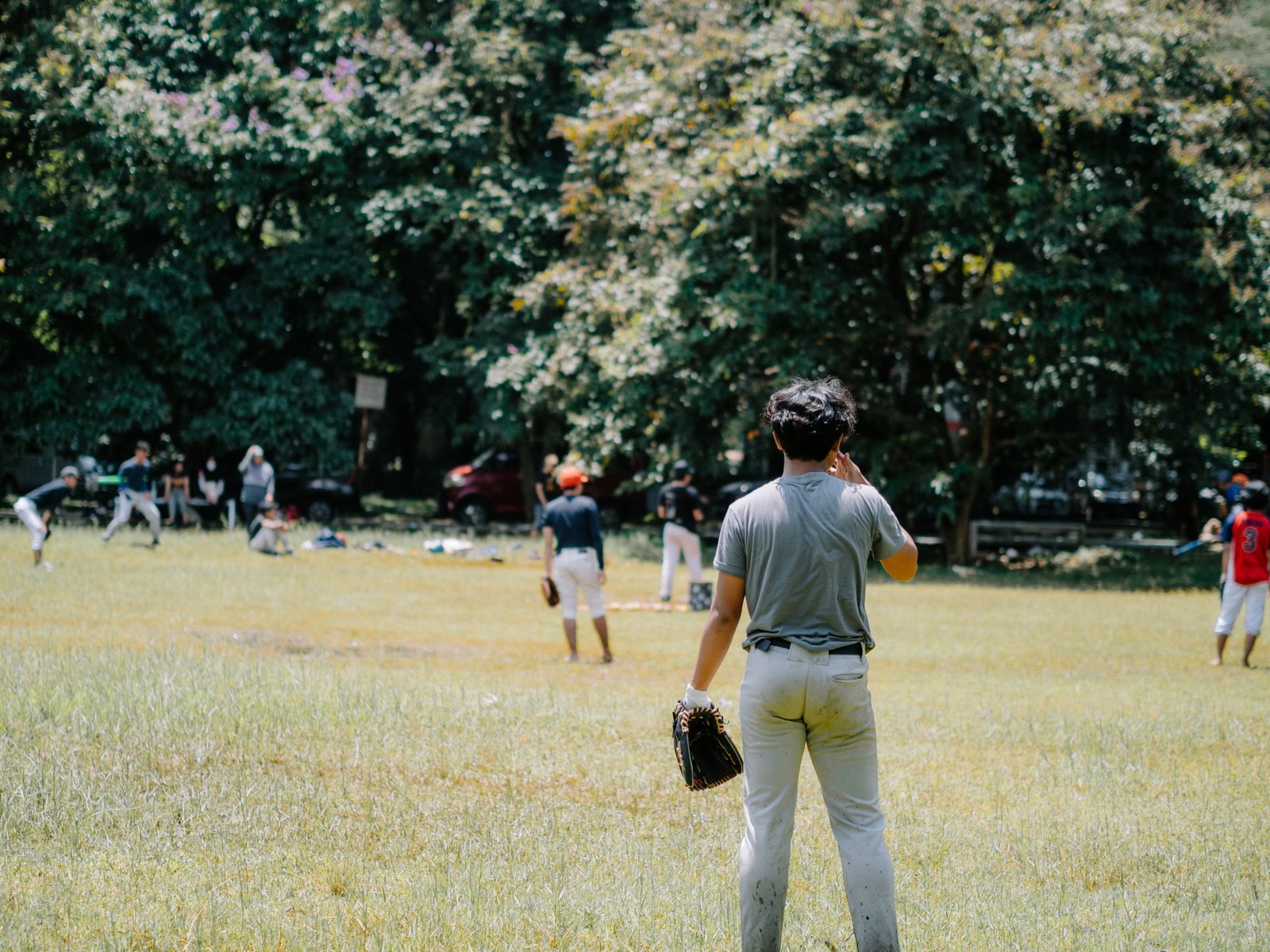 Young athletes competing and practicing baseball skills during travel baseball tryouts outdoors