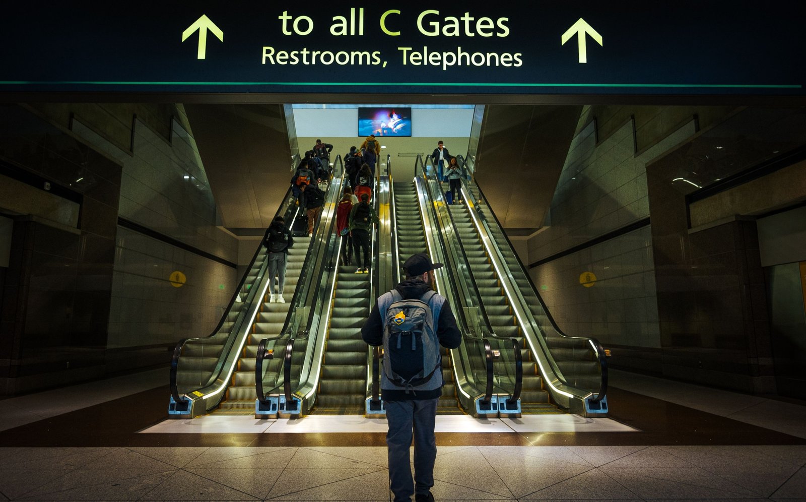 Standard Luggage Co. 35L travel backpack at the airport, designed for carry-on compliance and efficient organization