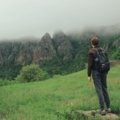 Brave outdoor traveler hiking confidently in nature with proper gear, symbolizing courage and preparedness for safe adventure