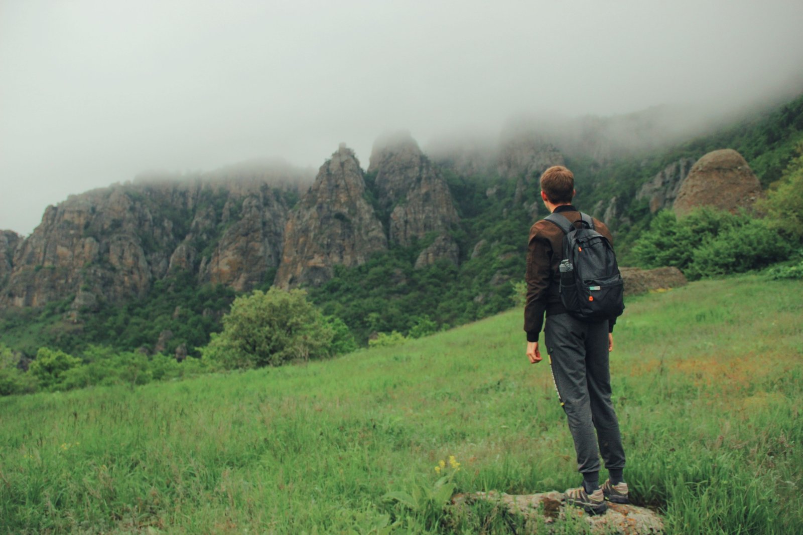 Brave outdoor traveler hiking confidently in nature with proper gear, symbolizing courage and preparedness for safe adventure