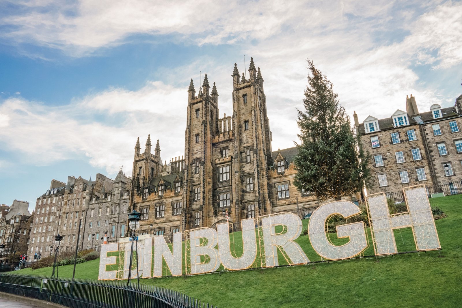 Travel advisor assisting client with personalized trip planning in Edinburgh featuring maps and travel guides