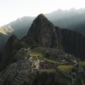 Breathtaking sunrise view of Machu Picchu ancient Inca ruins surrounded by green mountains in Peru