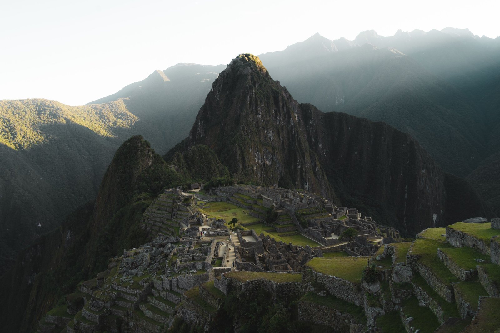 Breathtaking sunrise view of Machu Picchu ancient Inca ruins surrounded by green mountains in Peru