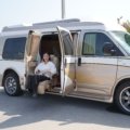 Compact and functional travel van bathroom interior with toilet and shower, illustrating comfort and convenience for road trips