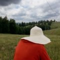 Woman wearing a wide brim travel sun hat for UV protection outdoors