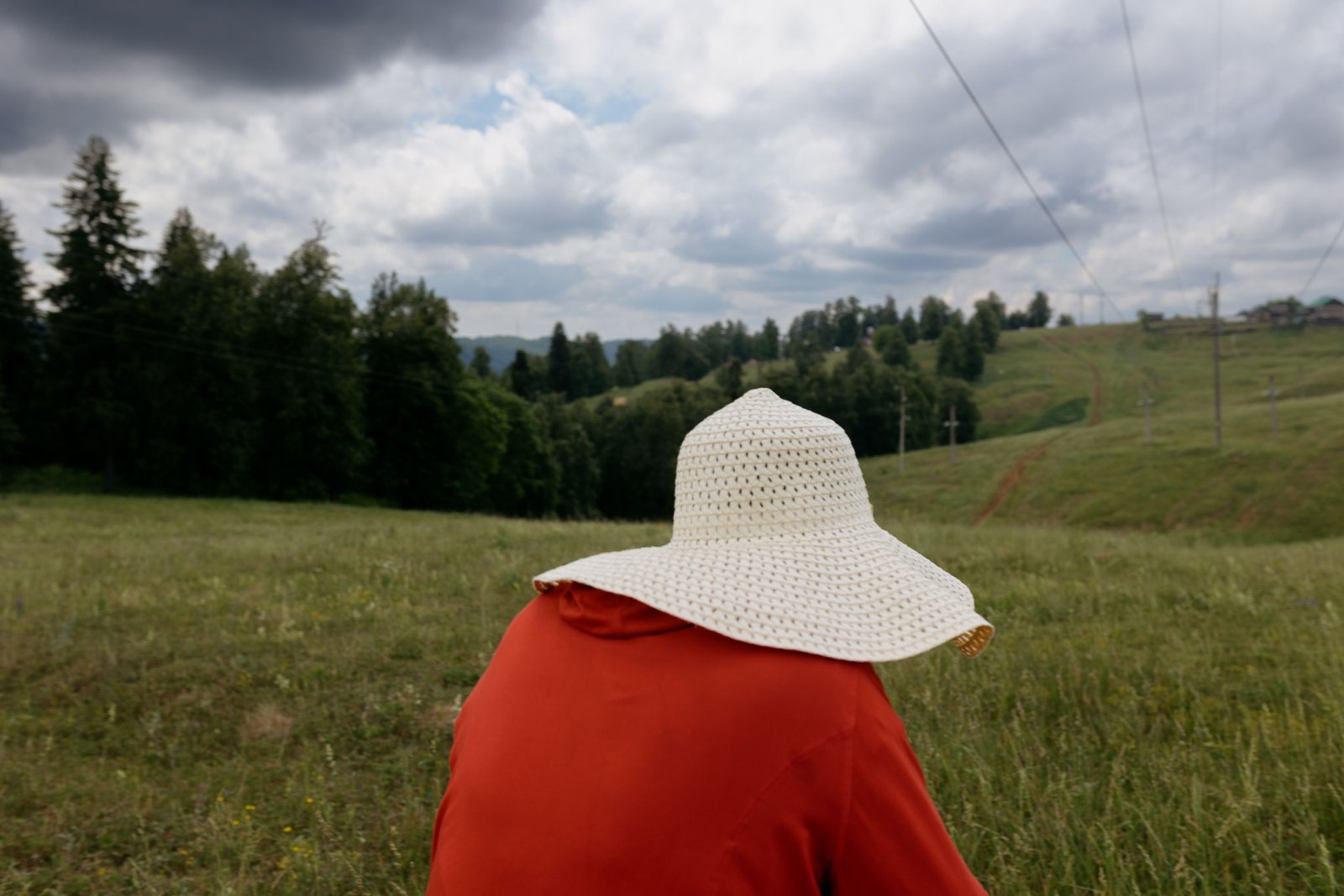 Woman wearing a wide brim travel sun hat for UV protection outdoors