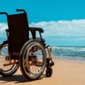 Traveler in wheelchair navigating an airport with accessible travel equipment and assistance for spinal cord injury