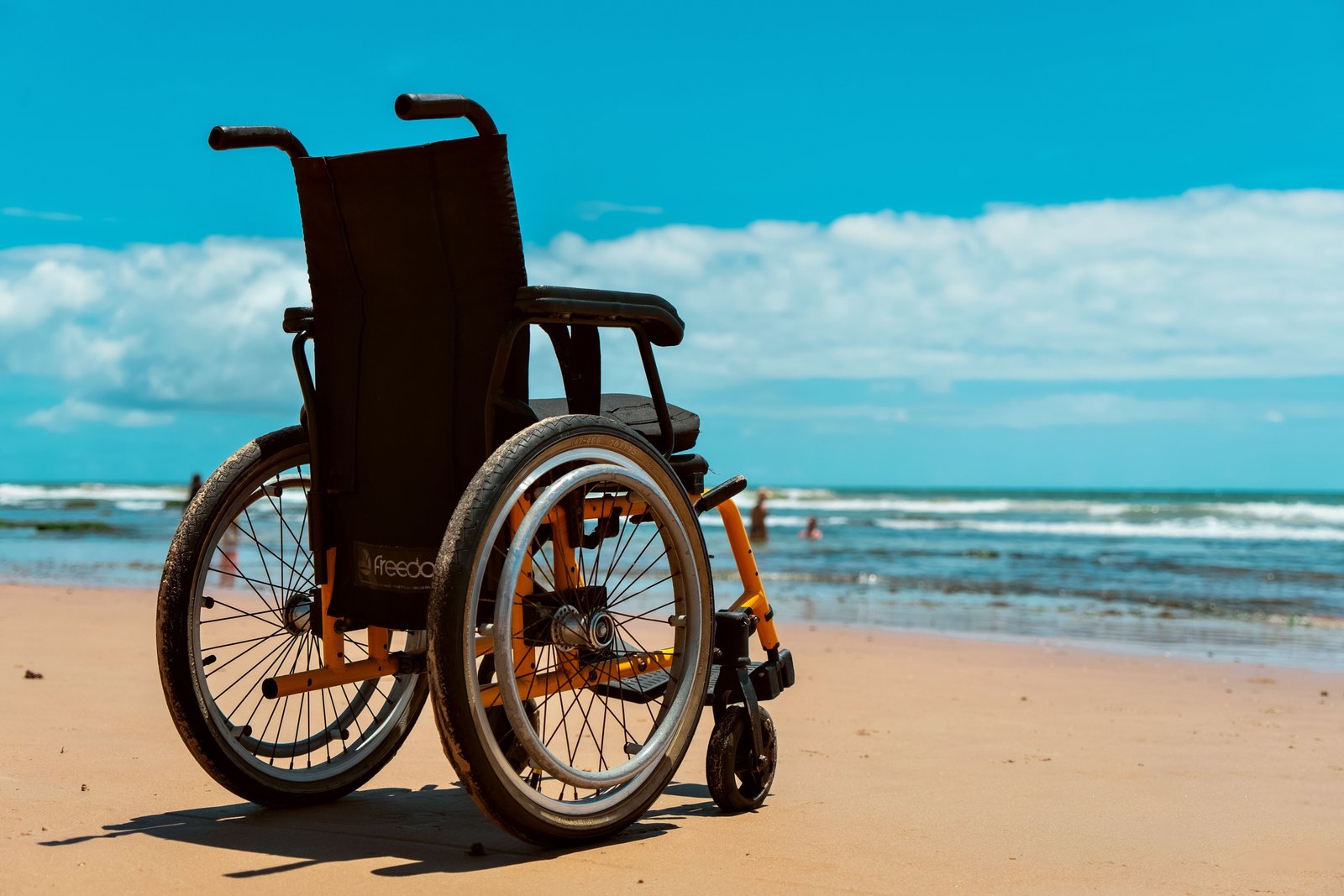 Traveler in wheelchair navigating an airport with accessible travel equipment and assistance for spinal cord injury