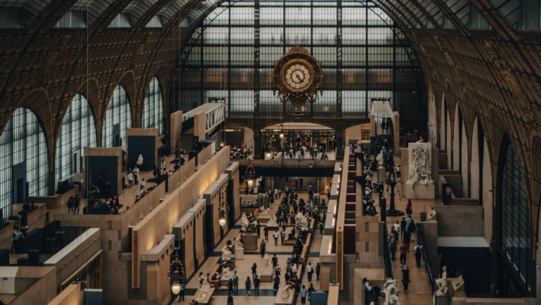 Visitors exploring art exhibitions in a famous Paris museum showcasing classic and modern artworks in 2023
