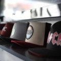 Baseball hats neatly organized inside a hard shell travel case for protection during travel