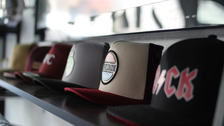 Baseball hats neatly organized inside a hard shell travel case for protection during travel