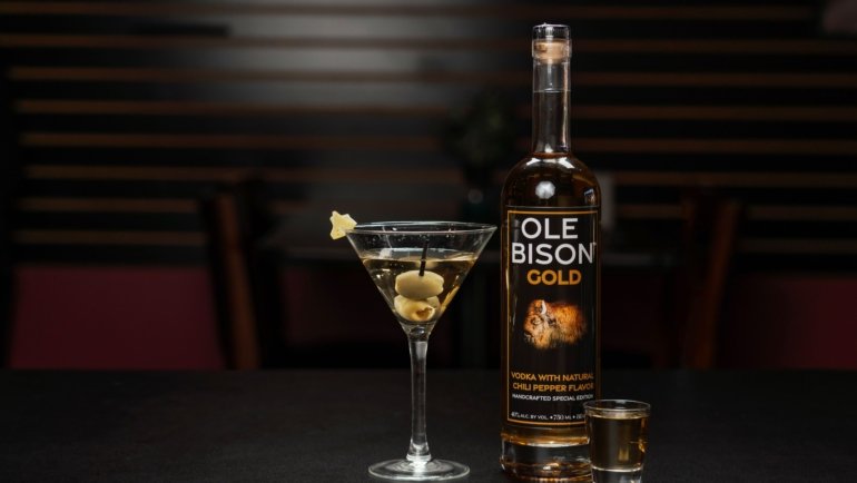 Premium Travelers Club Vodka bottle with travel-themed props representing elegance and global heritage