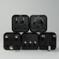 Switzerland travel adapter plugged into Swiss power outlet with Type C and Type J plugs, essential for safe device charging while traveling