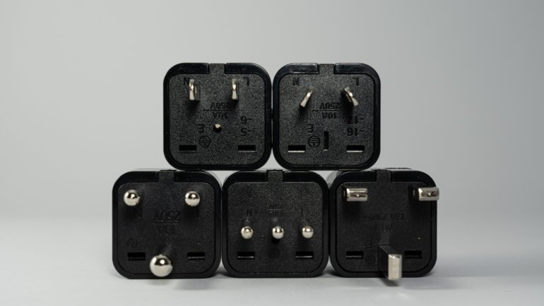 Switzerland travel adapter plugged into Swiss power outlet with Type C and Type J plugs, essential for safe device charging while traveling