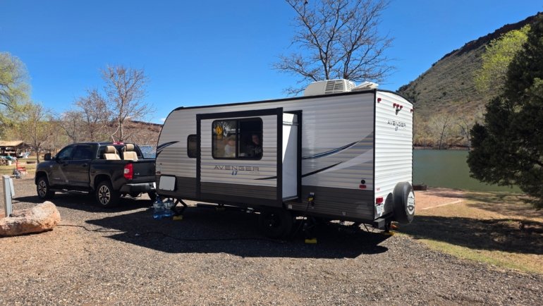 Jayco Jay Flight SLX travel trailer parked in nature, showcasing lightweight design and comfortable camping setup