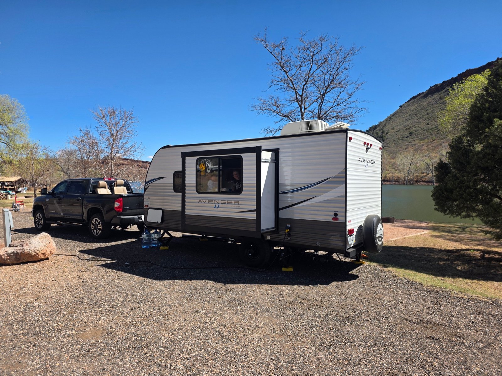 Jayco Jay Flight SLX travel trailer parked in nature, showcasing lightweight design and comfortable camping setup