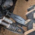 Polaris Ranger with upgraded long travel suspension kit driving on rugged off-road terrain