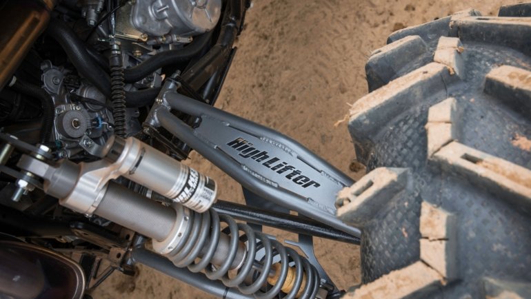Polaris Ranger with upgraded long travel suspension kit driving on rugged off-road terrain