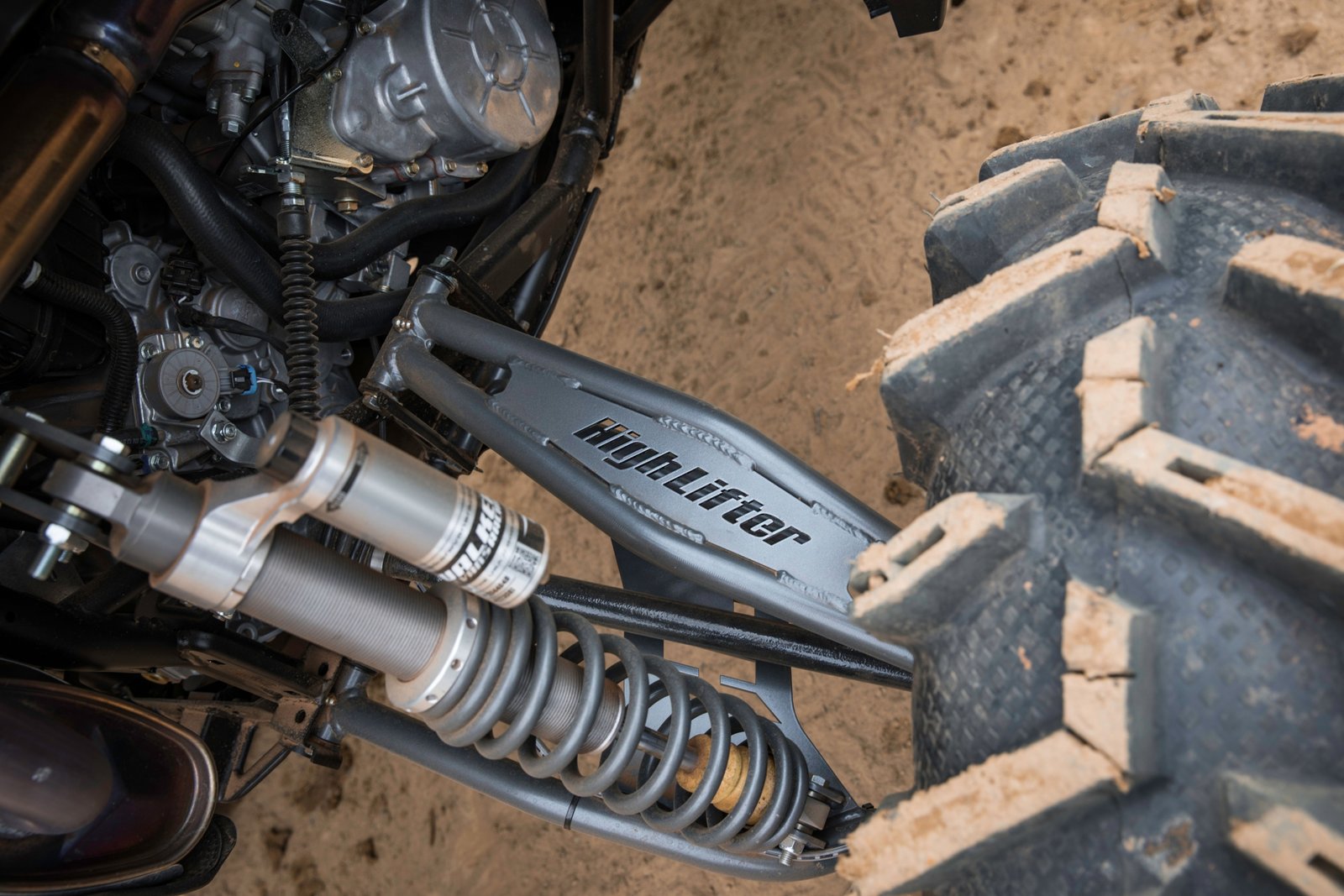 Polaris Ranger with upgraded long travel suspension kit driving on rugged off-road terrain