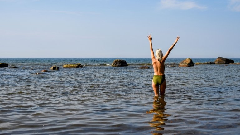Happy naturist travelers enjoying a clothing-free beach experience with respect and freedom