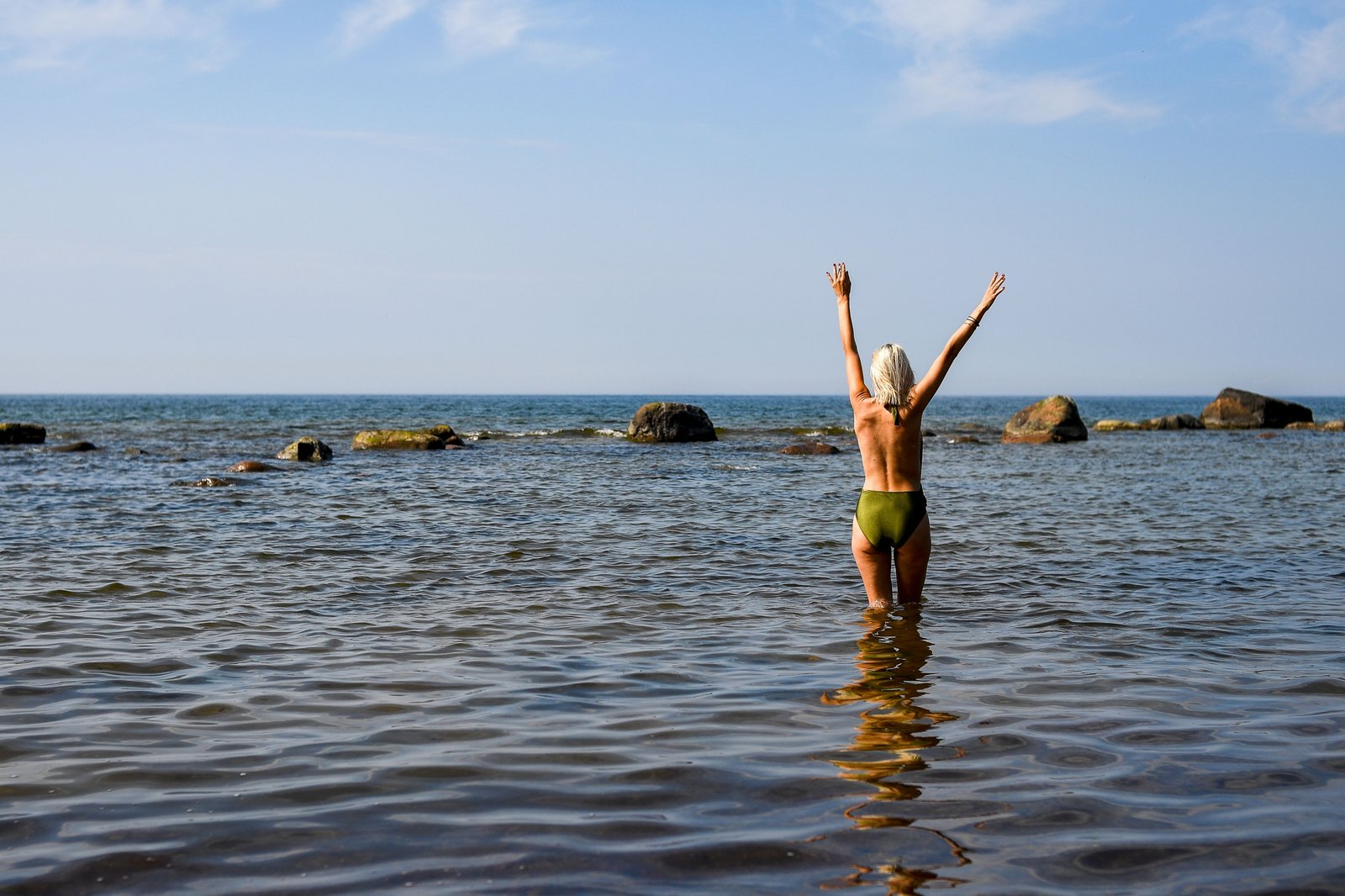 Happy naturist travelers enjoying a clothing-free beach experience with respect and freedom
