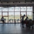 Family traveling with baby using a Nuna travel stroller and car seat at the airport