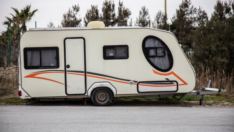 Gulfstream travel trailer parked outdoors surrounded by nature, highlighting comfort and reliable design for road adventures