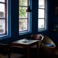 Traveler enjoying a cozy Scandinavian café with warm lighting and comfortable surroundings embracing hygge travel experience