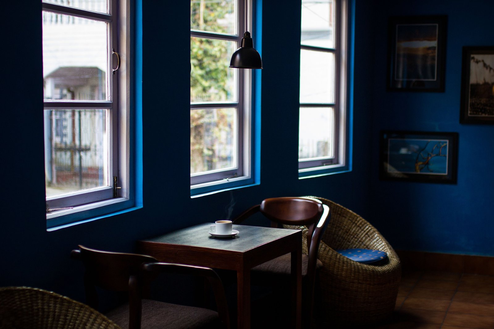 Traveler enjoying a cozy Scandinavian café with warm lighting and comfortable surroundings embracing hygge travel experience