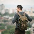 Compact 25 litre travel backpack worn by traveler on outdoor adventure, showcasing lightweight and organized design