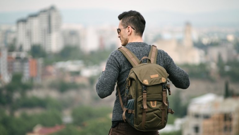 Compact 25 litre travel backpack worn by traveler on outdoor adventure, showcasing lightweight and organized design