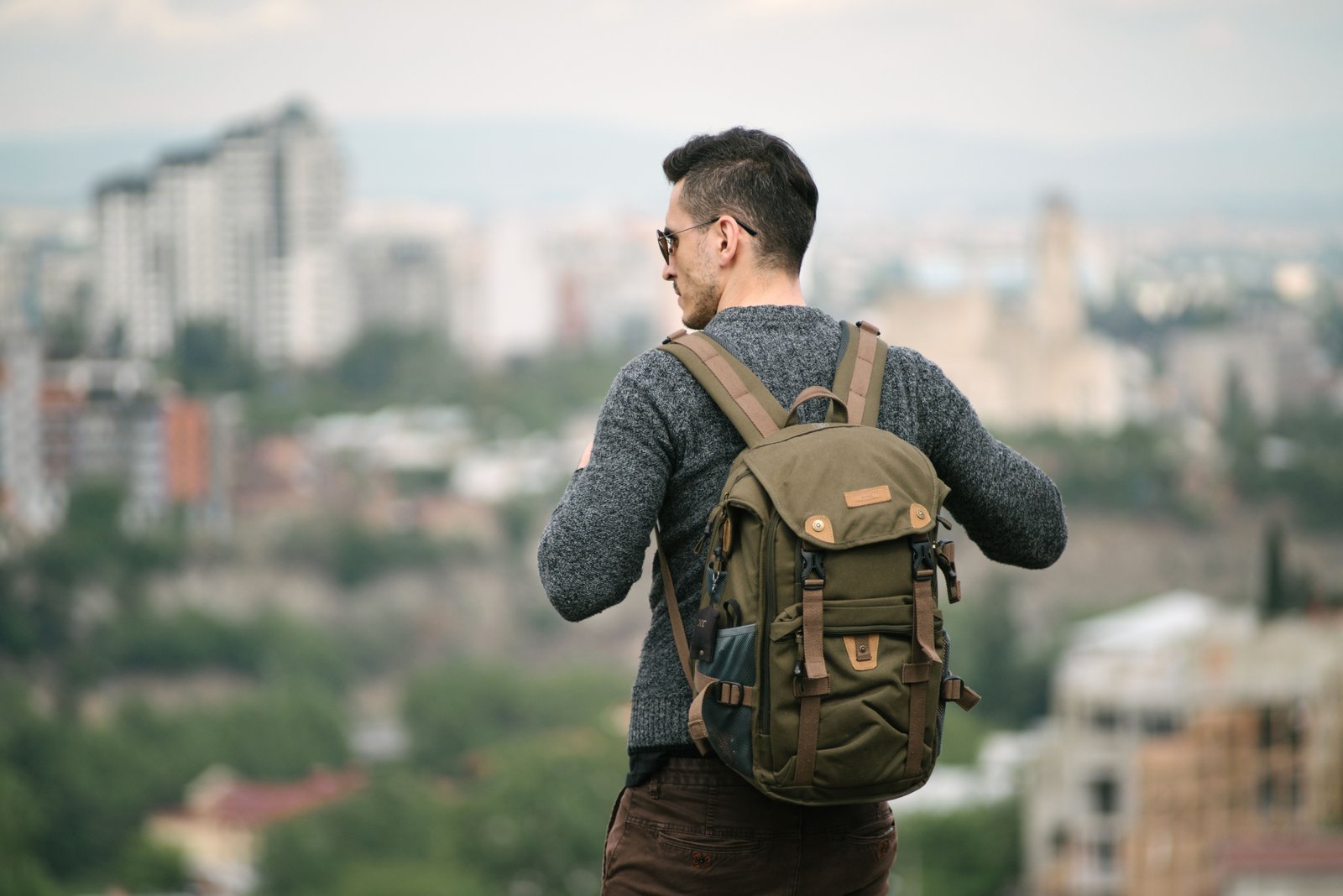 Compact 25 litre travel backpack worn by traveler on outdoor adventure, showcasing lightweight and organized design