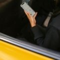 Traveler using smartphone with travel applications for navigation and booking during trip planning