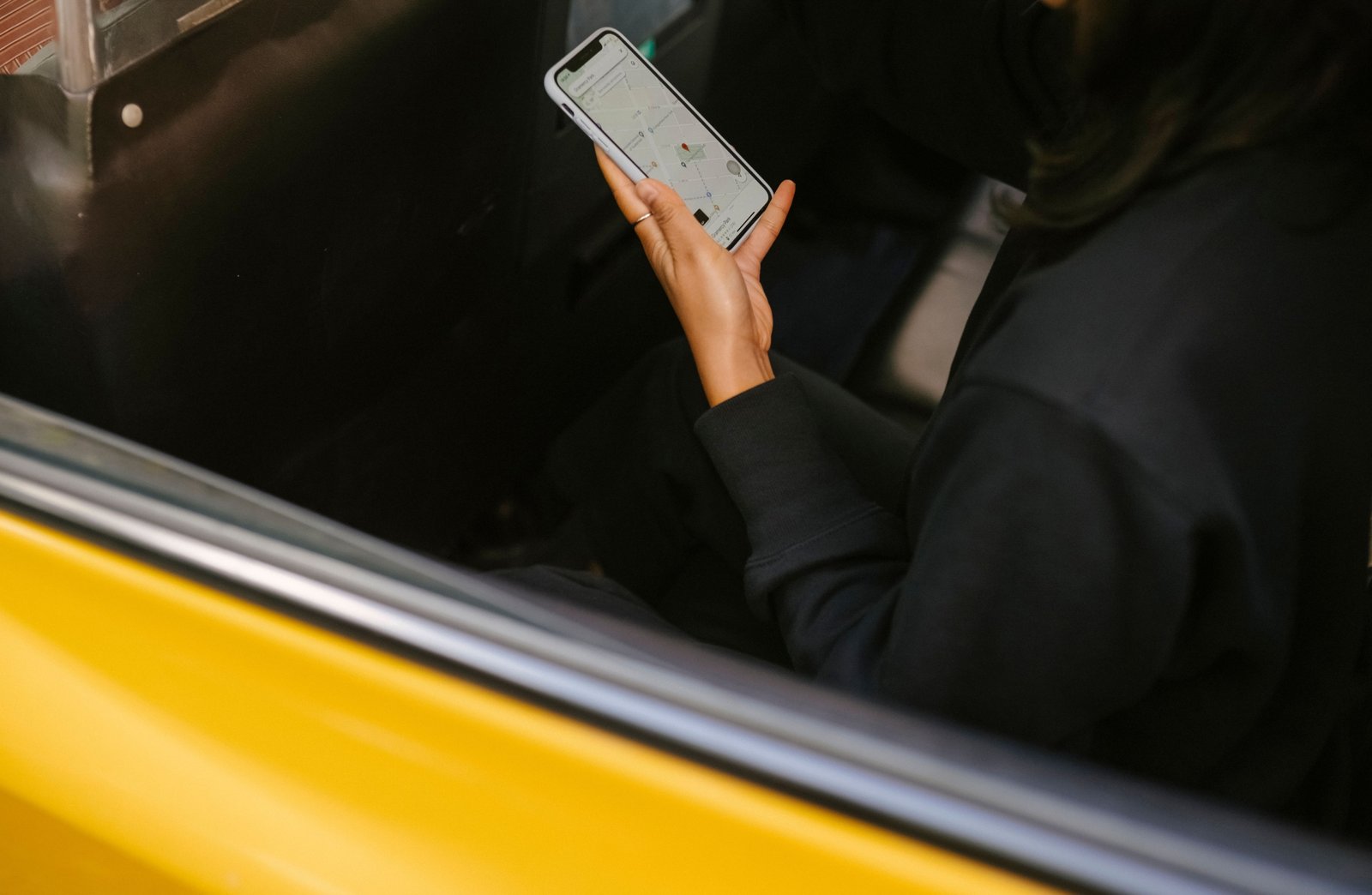 Traveler using smartphone with travel applications for navigation and booking during trip planning