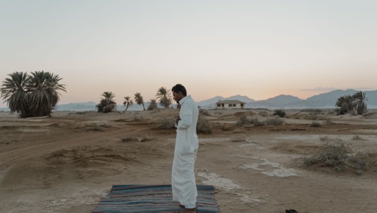 Portable travel prayer mat for Muslim prayer outdoors showing convenience and spiritual practice while traveling