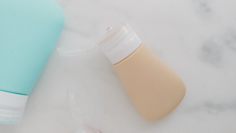 Eco-friendly travel set with reusable toiletry bottles and natural skincare products packed neatly for sustainable travel