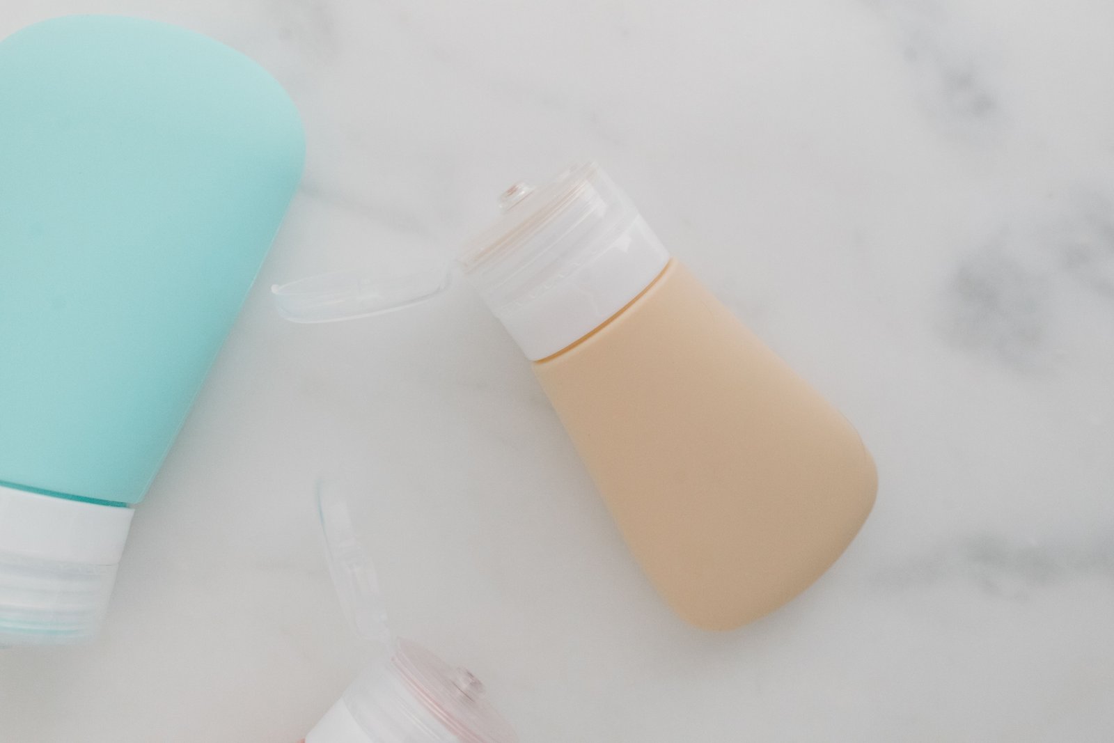 Eco-friendly travel set with reusable toiletry bottles and natural skincare products packed neatly for sustainable travel