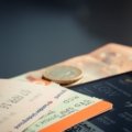 Traveler organizing and prioritizing flights, hotels, and car rentals on smartphone for seamless trip planning
