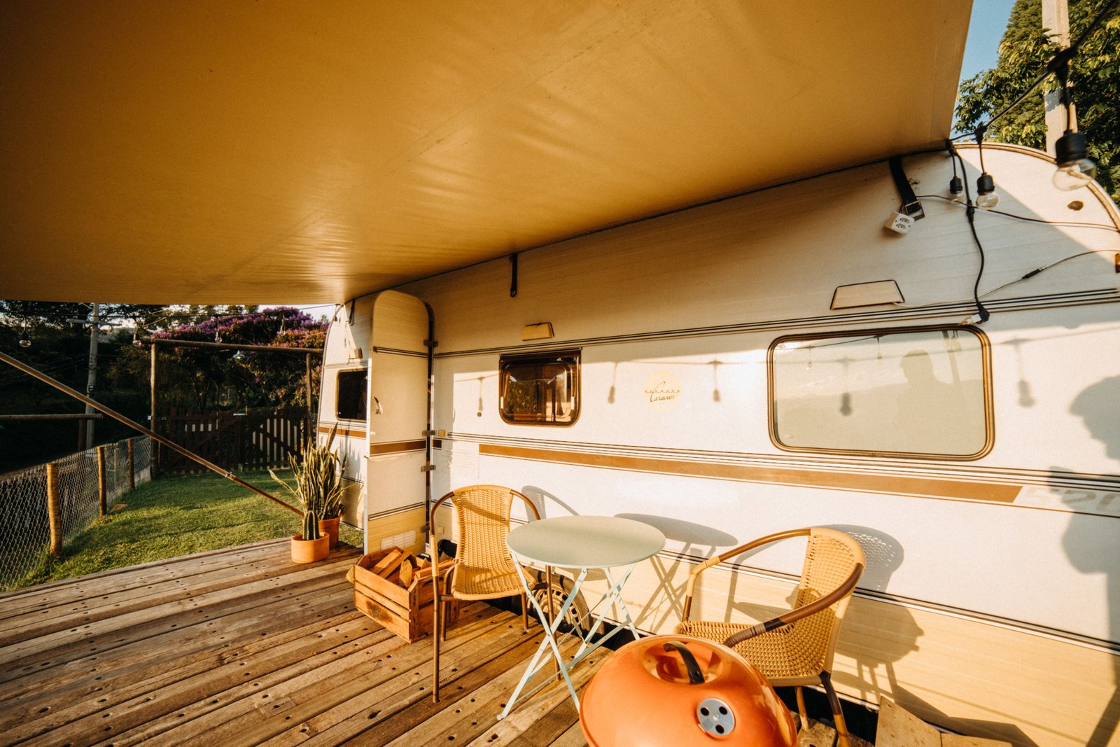 Travel trailer patio with a protective canopy providing shade and shelter for outdoor comfort and leisure