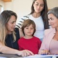 Travel agent helping family plan a magical Disney vacation with smiles and Disney brochures