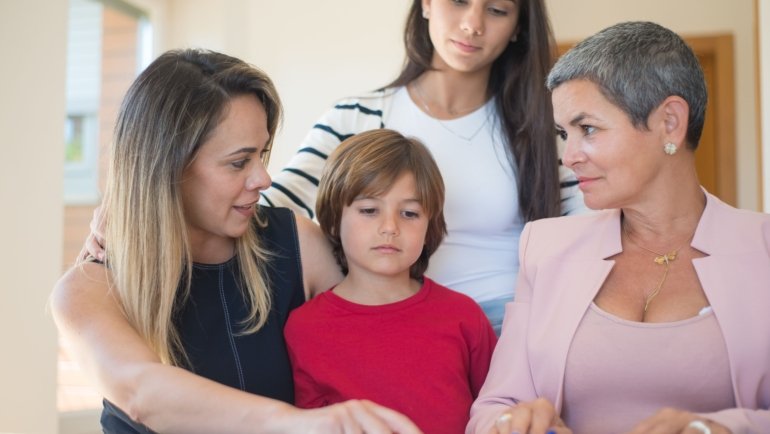 Travel agent helping family plan a magical Disney vacation with smiles and Disney brochures