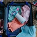Compact travel pump bottle being packed into luggage for organized and hygienic travel