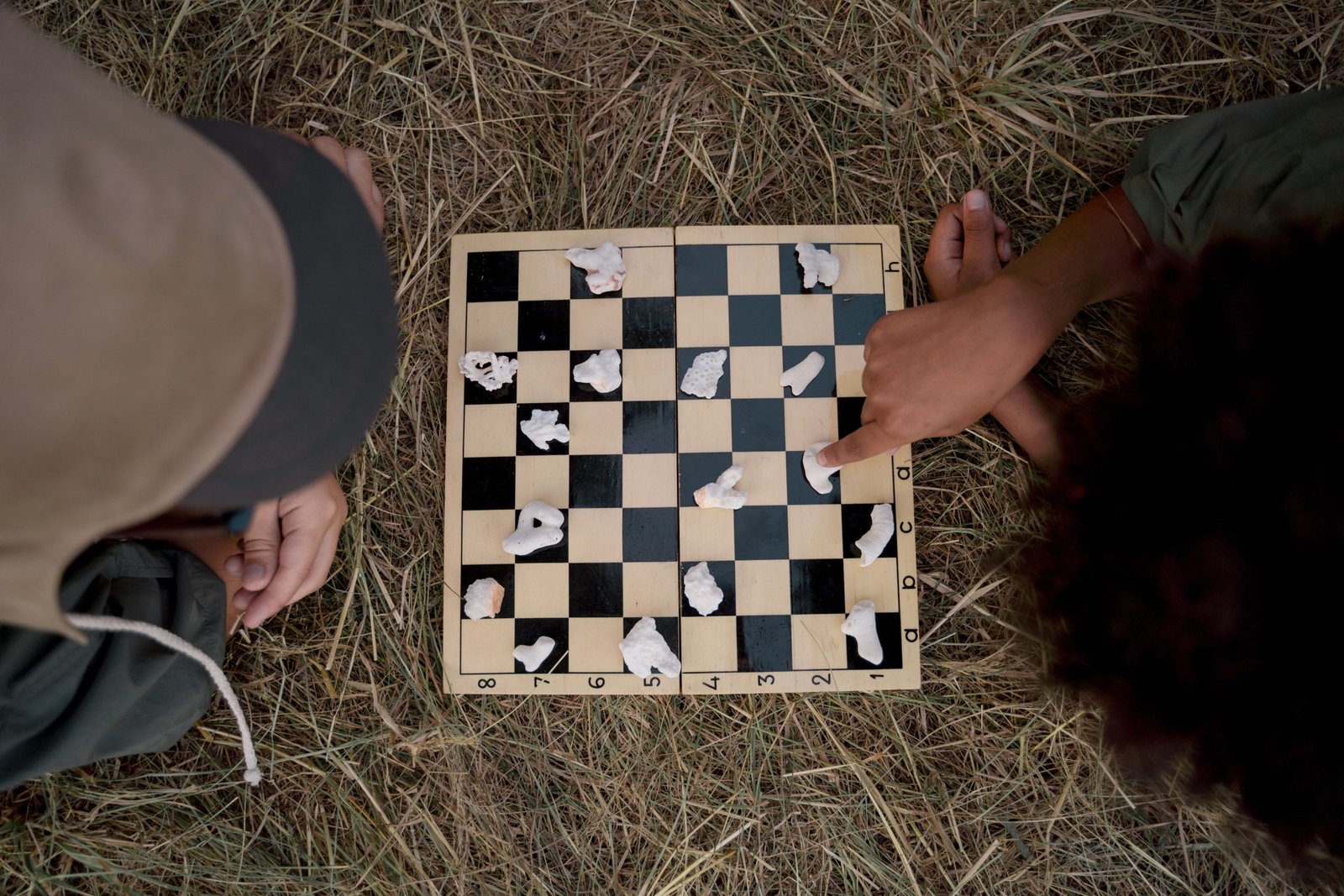 portable magnetic travel chess set in outdoor setting with person playing chess