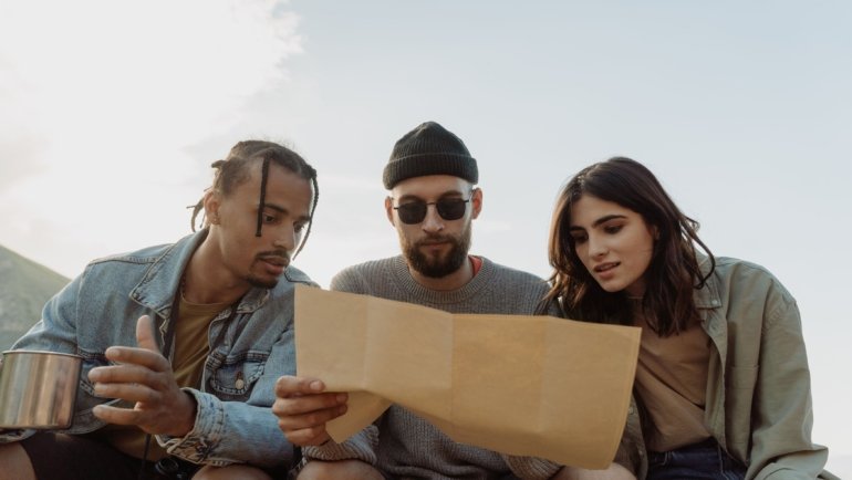 Diverse group of travelers engaged in planning unique adventures representing various travel personalities and styles