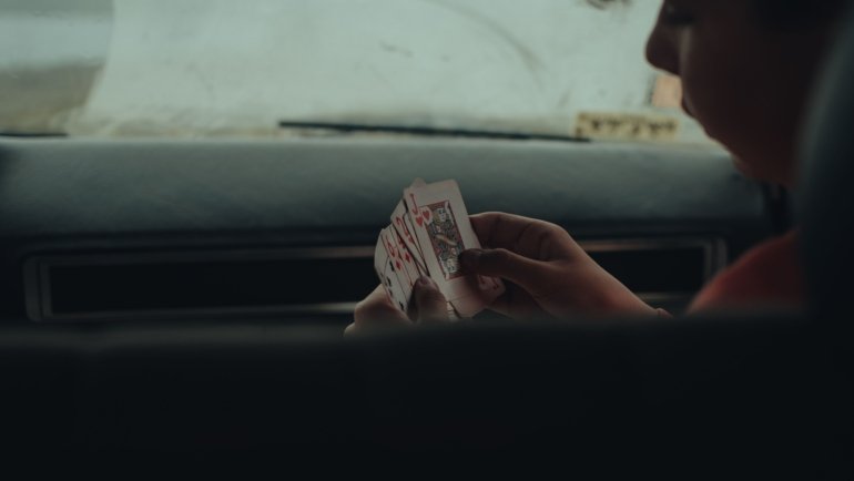 Group of travelers playing portable board and card games during a road trip to pass time and enjoy entertainment