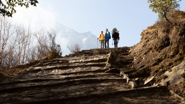 Trekking in Nepal Himalayas during autumn season with clear skies and vibrant mountain views